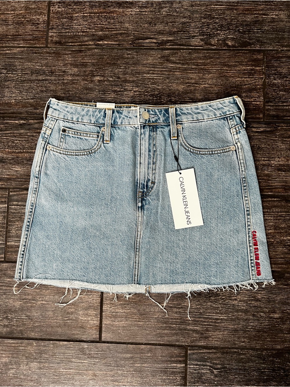 Calvin Klein Light Wash Denim Mini Skirt with Frayed Hem